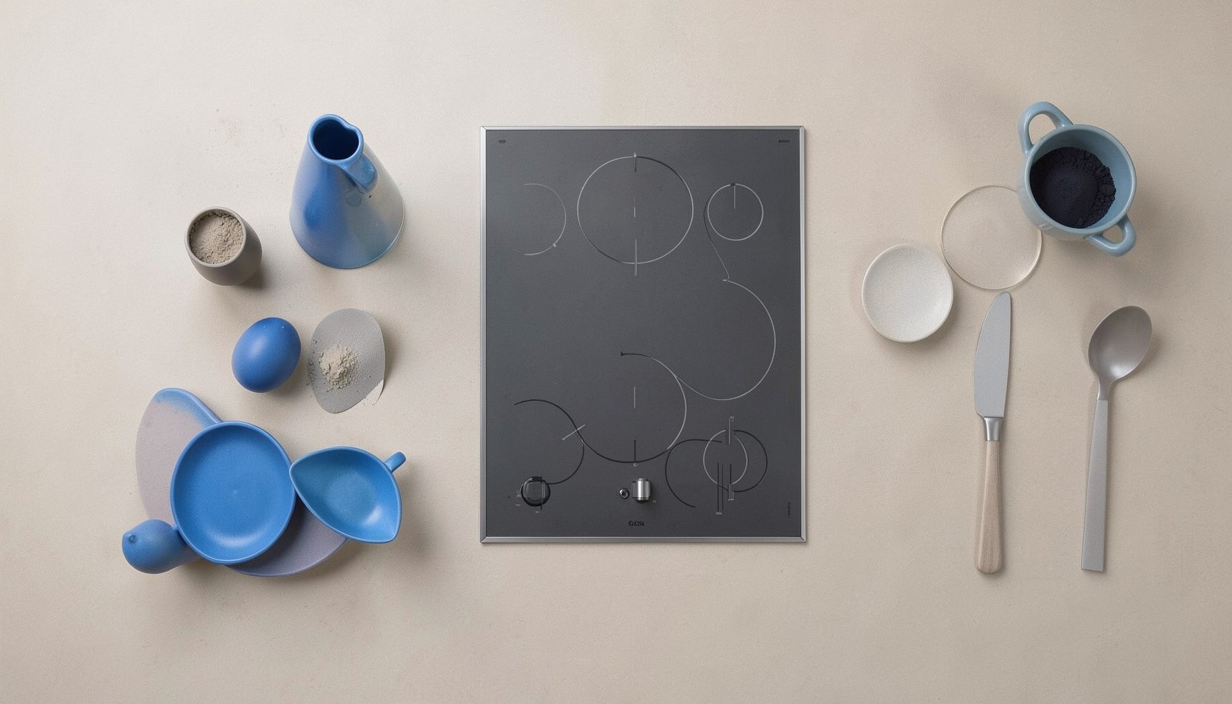 Cuisine moderne avec four et plaque de cuisson encastrés dans un plan de travail, tons neutres beige et gris, ambiance lumineuse et épurée